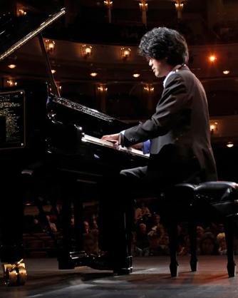 Sean Chen playing the piano on stage