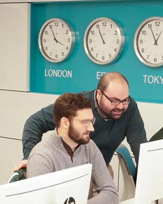 Dr. Christopher Mansour in a computer lab with students