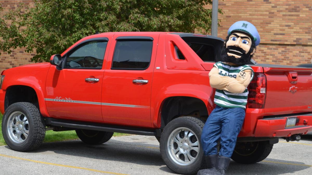 Luke standing with red truck