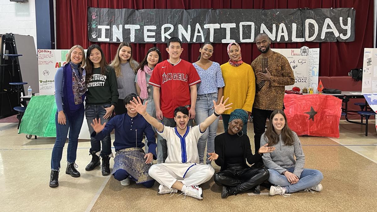 Mohcine “Mo” Khadraoui and 12 other Mercyhurst students posing for a photo on International Day