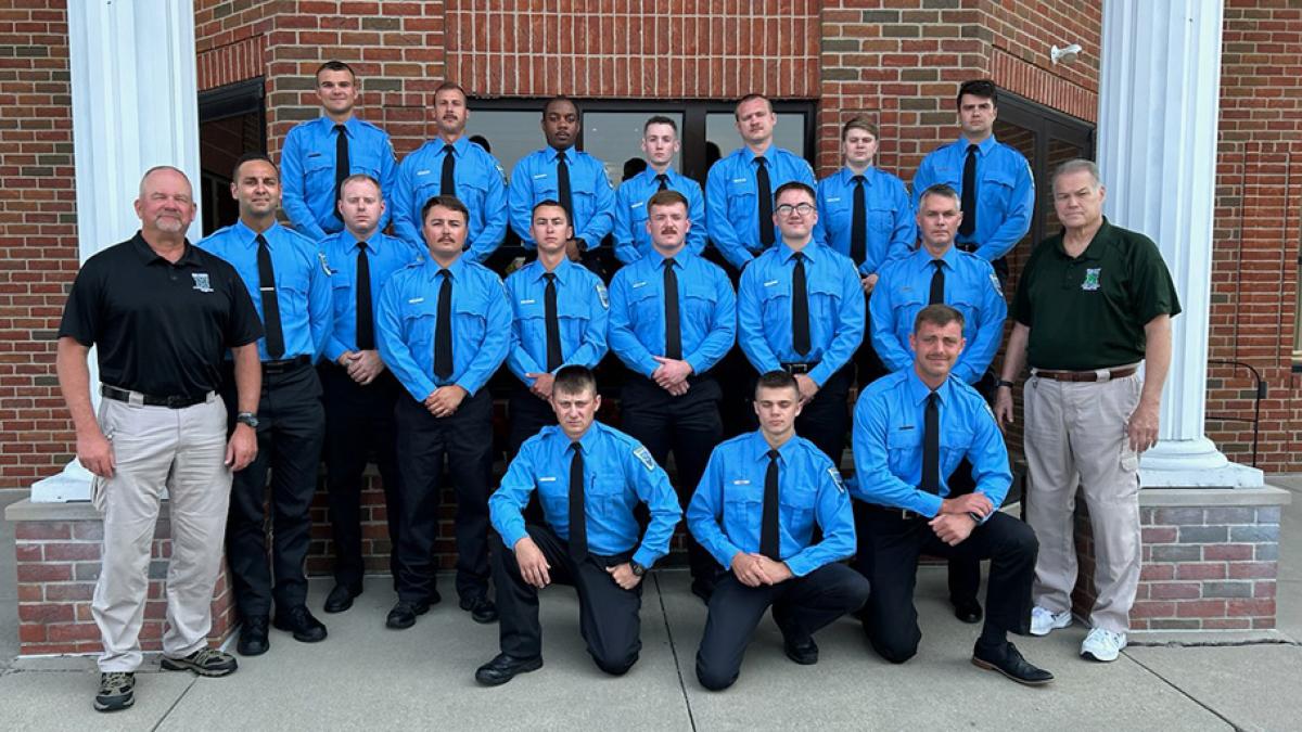 Summer 2024 cadet graduates, posing for a picture on stairs outdoors