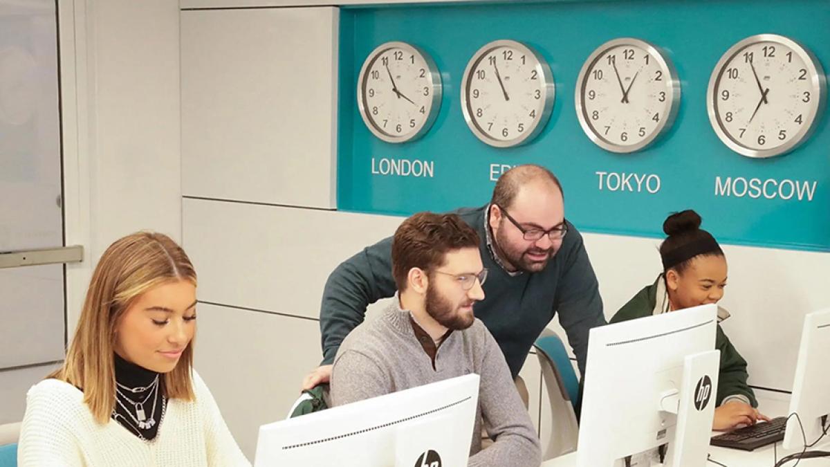 Dr. Christopher Mansour in a computer lab with students