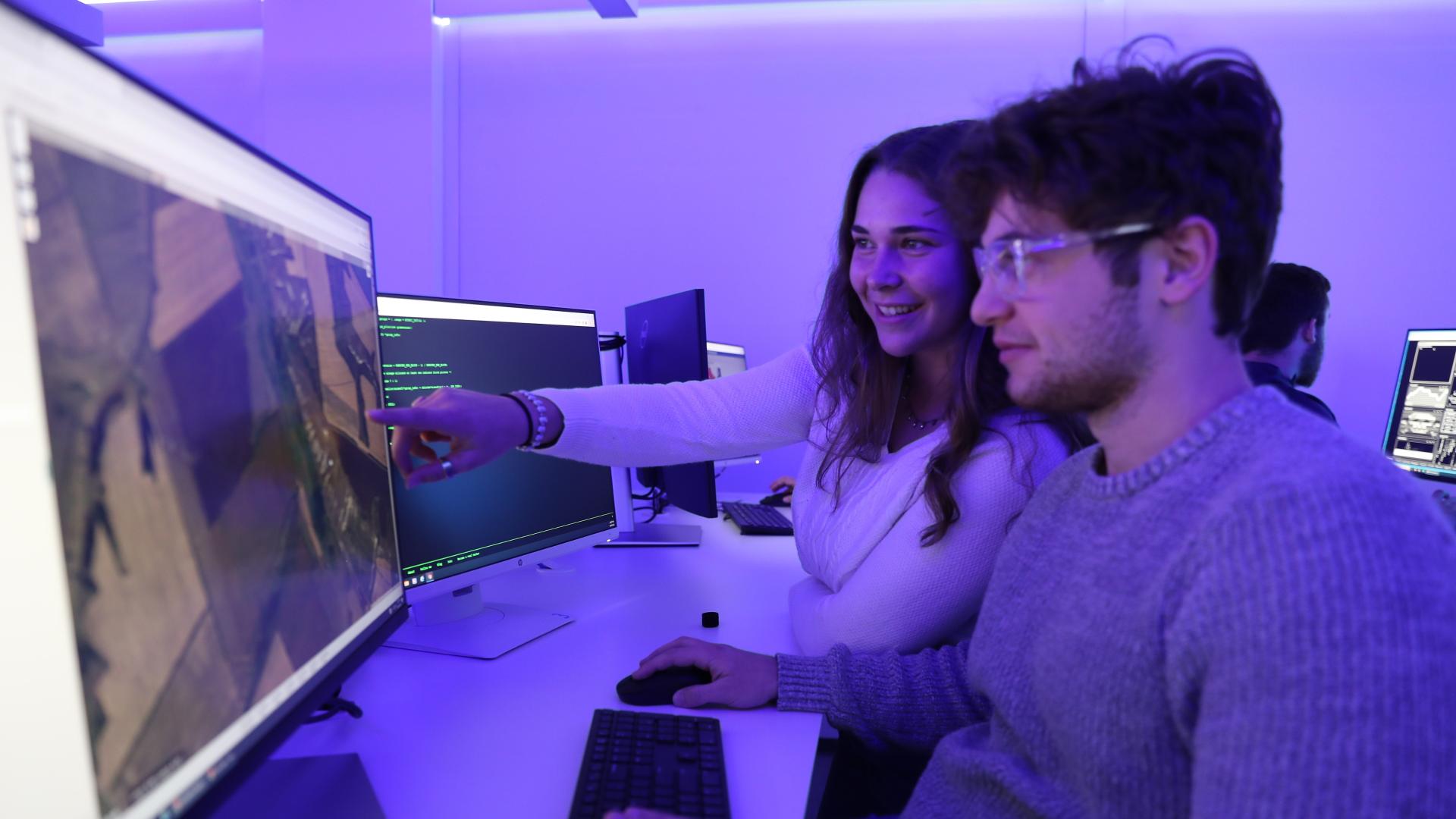 male and female student work together in cyber lab