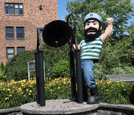 Luke stands with the bell