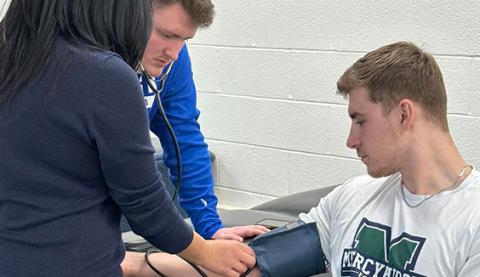 Physical Therapy Assistant students training on a patient