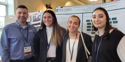 Dr McKay poses with another group of students at the conference