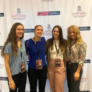 Dr. Parente poses with students at conference