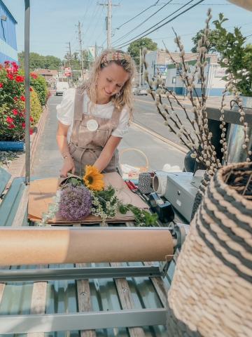 Maeve Gavin preparing flowers in the back of her truck bed