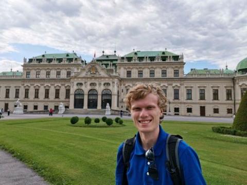 Joey Talarico in front of greenery and large building