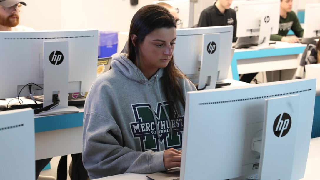 Student working on a computer in the Cyber lab