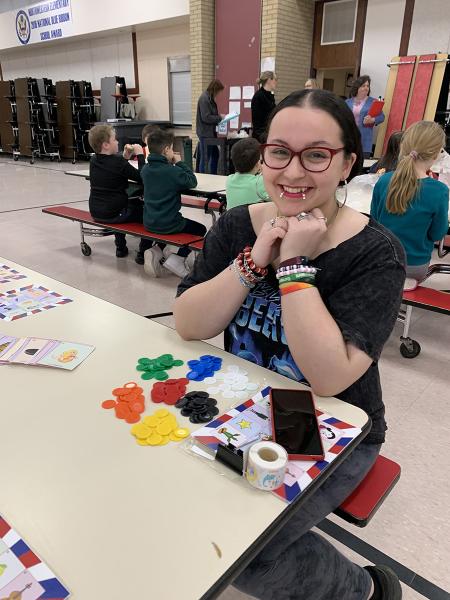 Female sitting at a table doing a colorful activity for French
