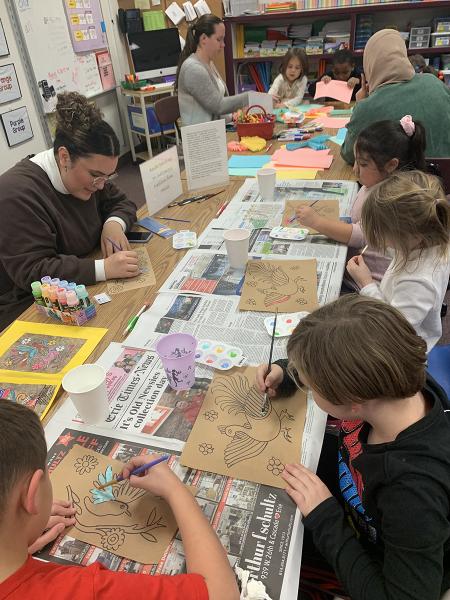 Females painting with children for Spanish class