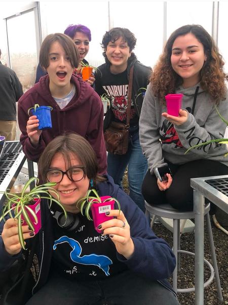 Image of kids holding plant in greenhouse